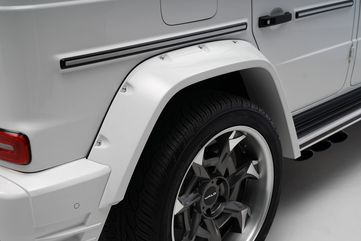 WALD Black Bison Mercedes G-Class W463A rear wide arch detail — ABS over fender with decorative screws over WALD wheel and side exit exhaust