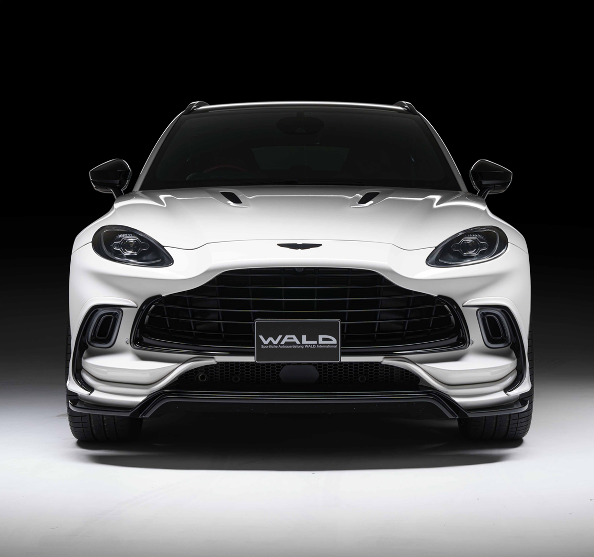 WALD Aston Martin body kit — white Aston Martin DBX with WALD front bumper and gloss black lower lip spoiler