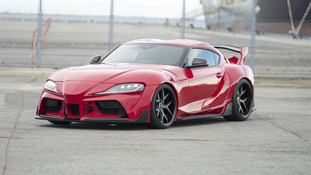 Red WALD Sports Line Wide Body Toyota Supra DB## front three-quarter view with wide fenders and front spoiler