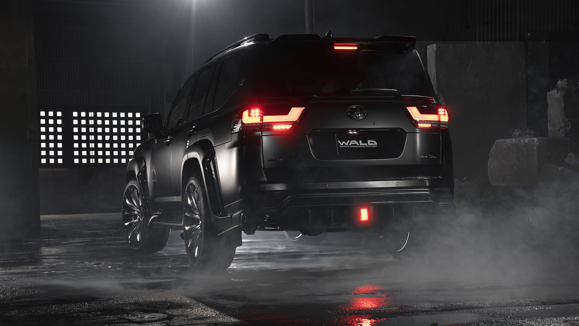 WALD Land Cruiser 300 ZX rear three-quarter view with rear skirt and illuminated tail lamps