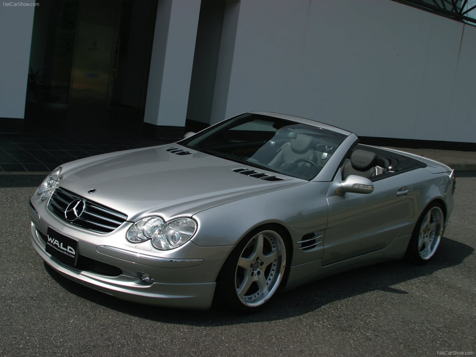WALD Executive Line Mercedes-Benz SL-Class R230 front three-quarter view with roof down outside a modern building