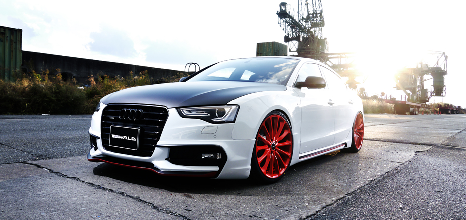 WALD Audi A5 Sportback S Line front body kit — white Audi A5 with WALD front lip spoiler and red WALD wheels