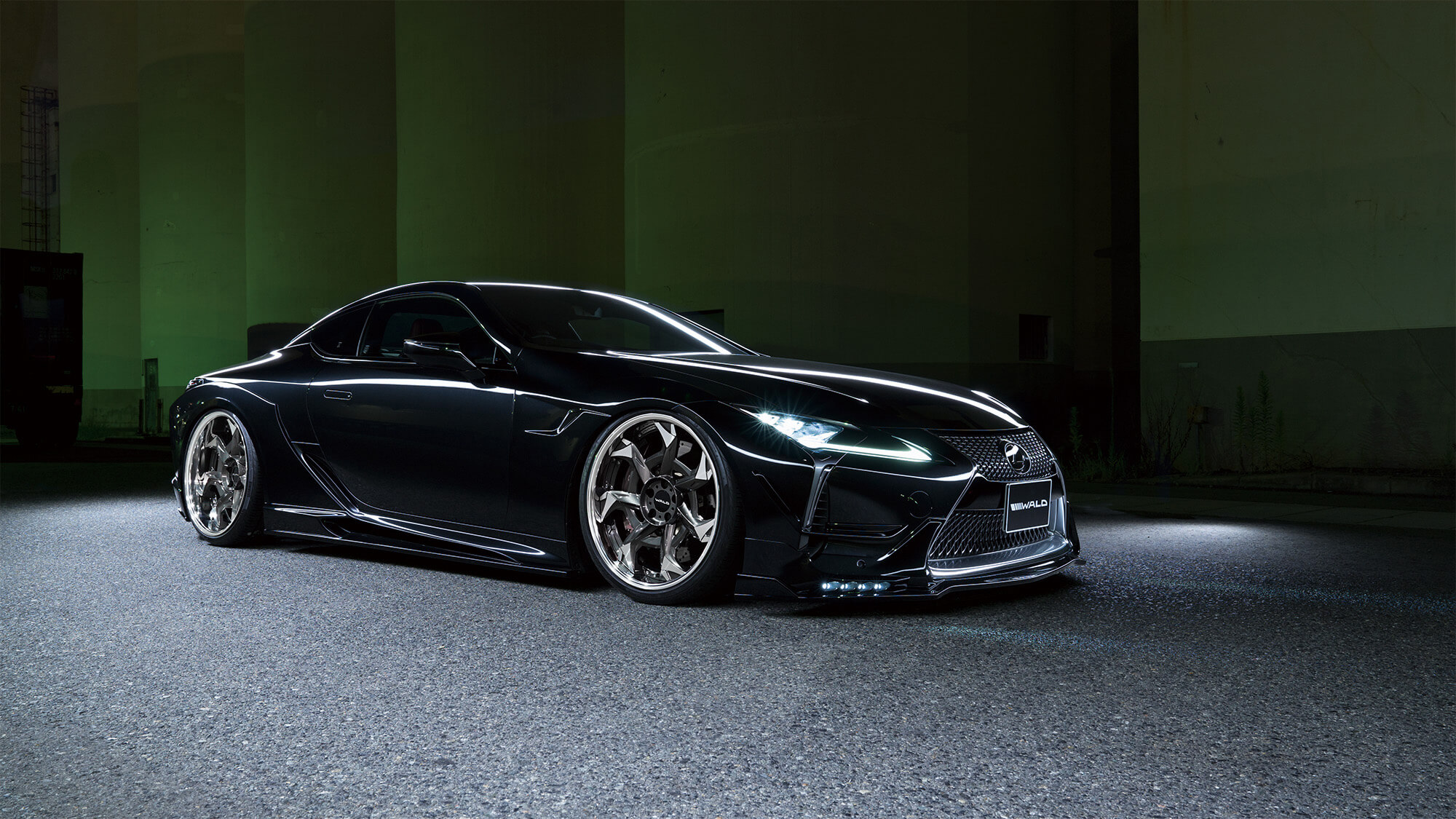 Black Lexus LC coupe with WALD body kit on Vorsalino V12C polished wheels at night