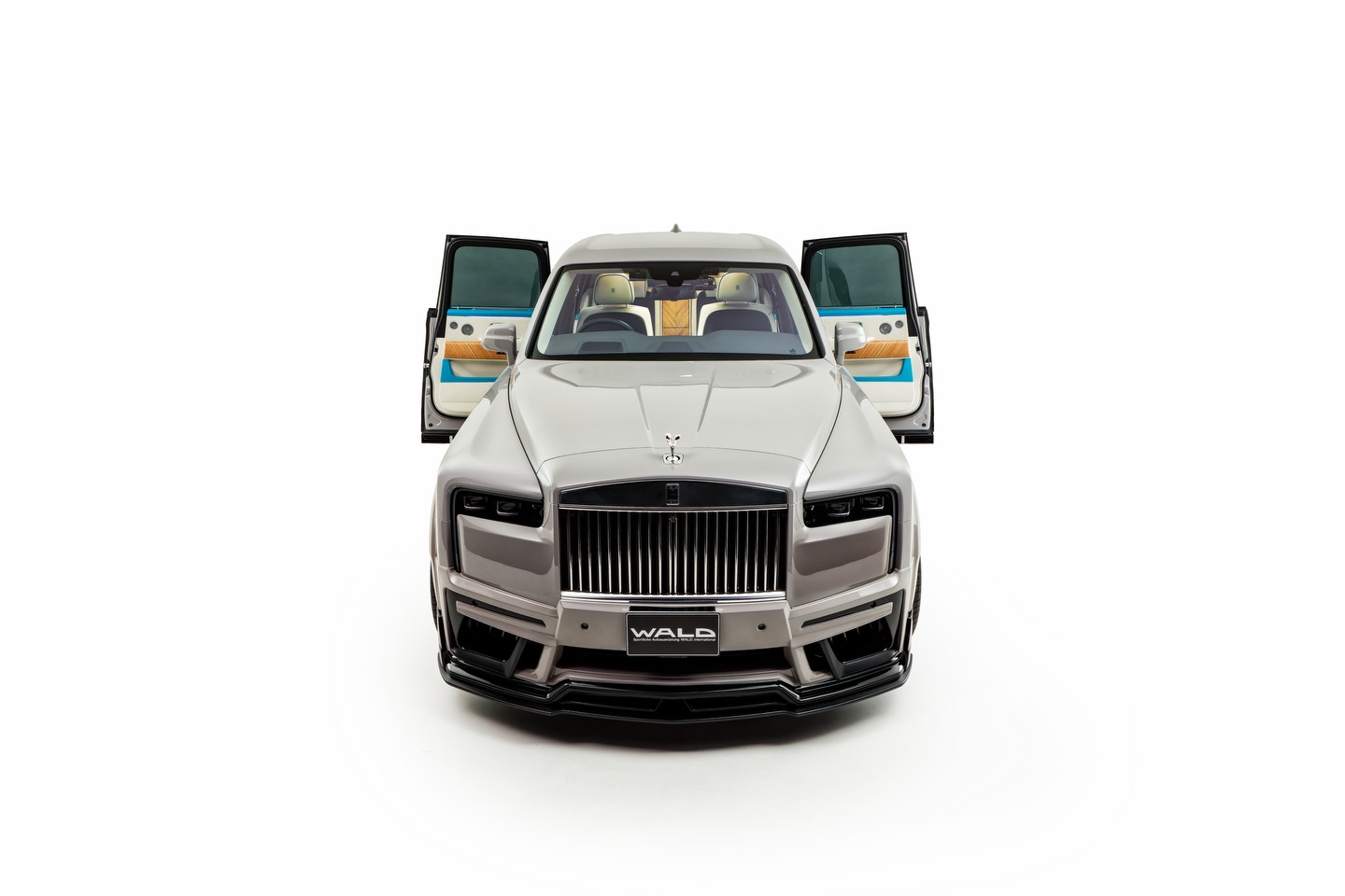WALD Rolls-Royce Cullinan | Premier Auto Design WALD Rolls-Royce Cullinan supplied by Premier Auto Design — head-on studio view with WALD wide-body front bumper, doors open showing the bespoke interior