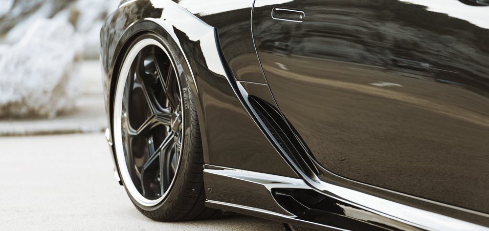 WALD Lexus LC500 side detail showing side skirt, rear fender duct and WALD wheel