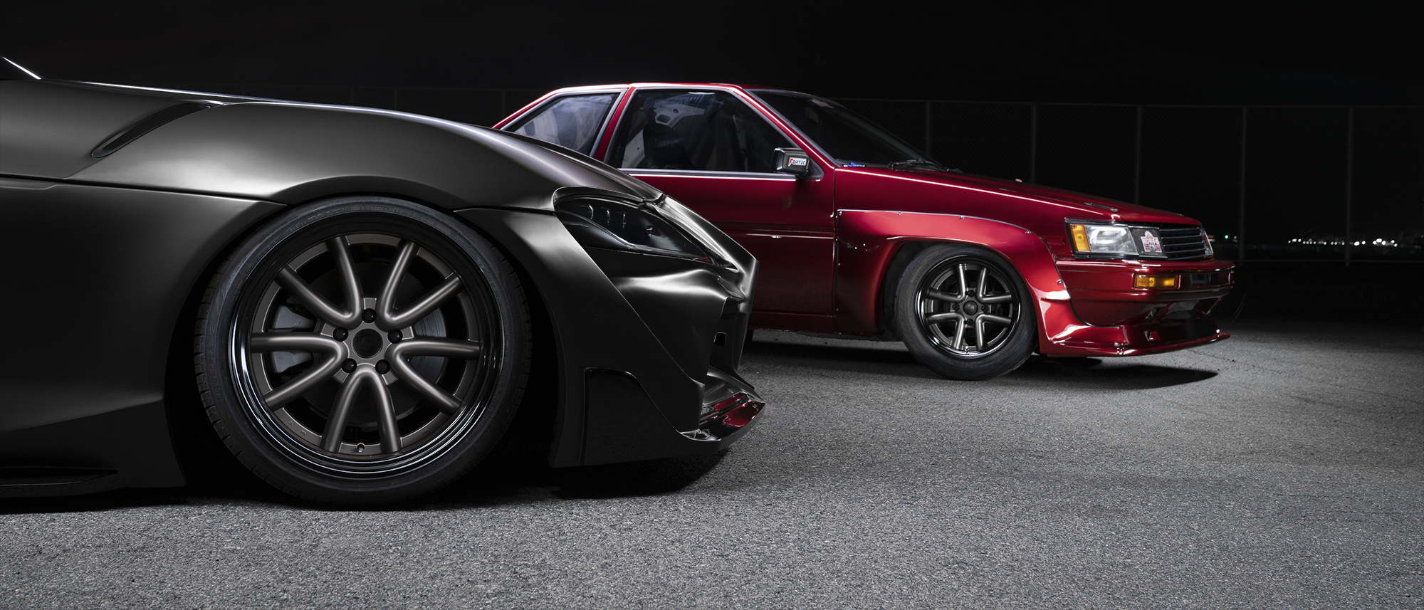Two vehicles at night showing WALD Octopus Racing wheels in Matte Bronze and Matte Black