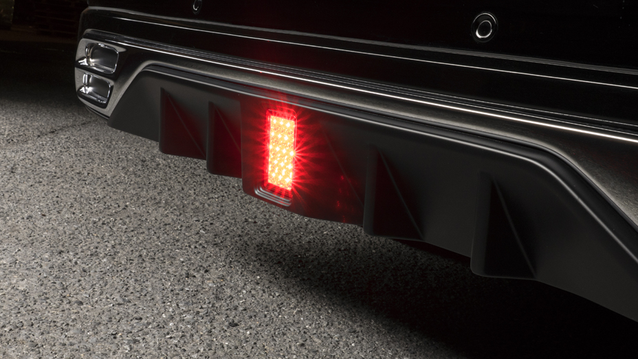 WALD Land Cruiser 200 rear skirt detail — diffuser fins with illuminated LED rear fog lamp and oval exhaust tip