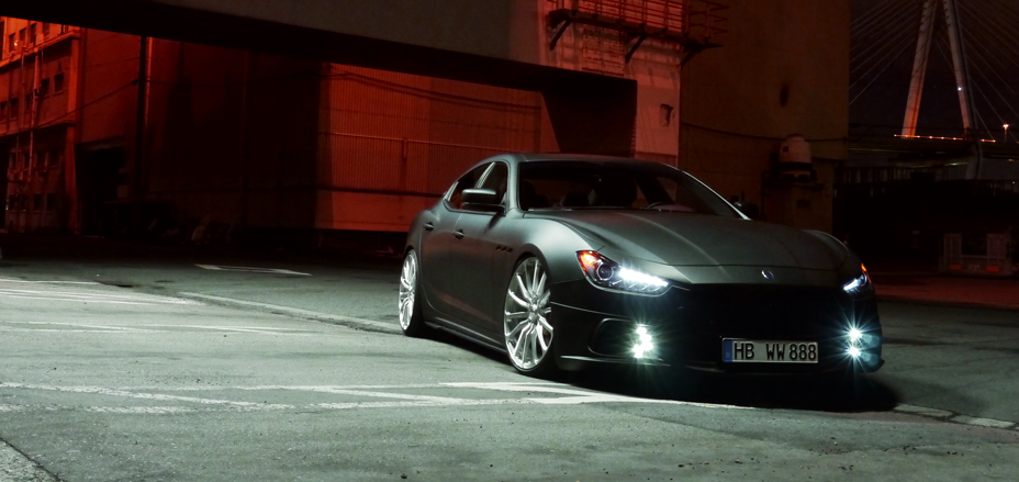 Maserati Ghibli WALD Black Bison Edition at night — front three-quarter view with lights on