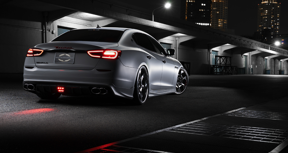 WALD Maserati Quattroporte rear three-quarter view with illuminated rear LED lamp at night