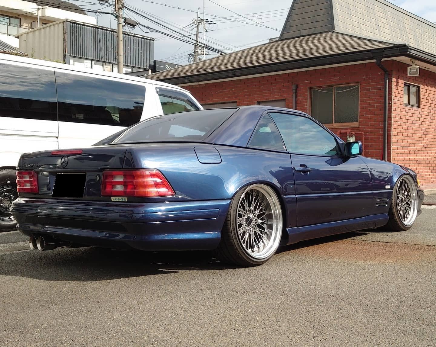 WALD Mercedes-Benz SL-Class R129 rear three-quarter view with hardtop, deep-dish multi-spoke WALD wheels and twin exhaust tips