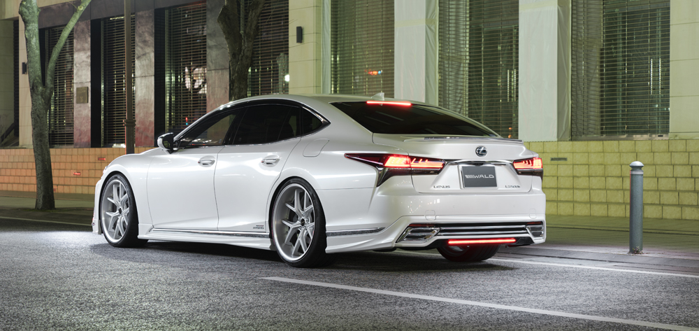 WALD Lexus LS500h rear three-quarter night view in white with WALD boot spoiler and LED rear skirt