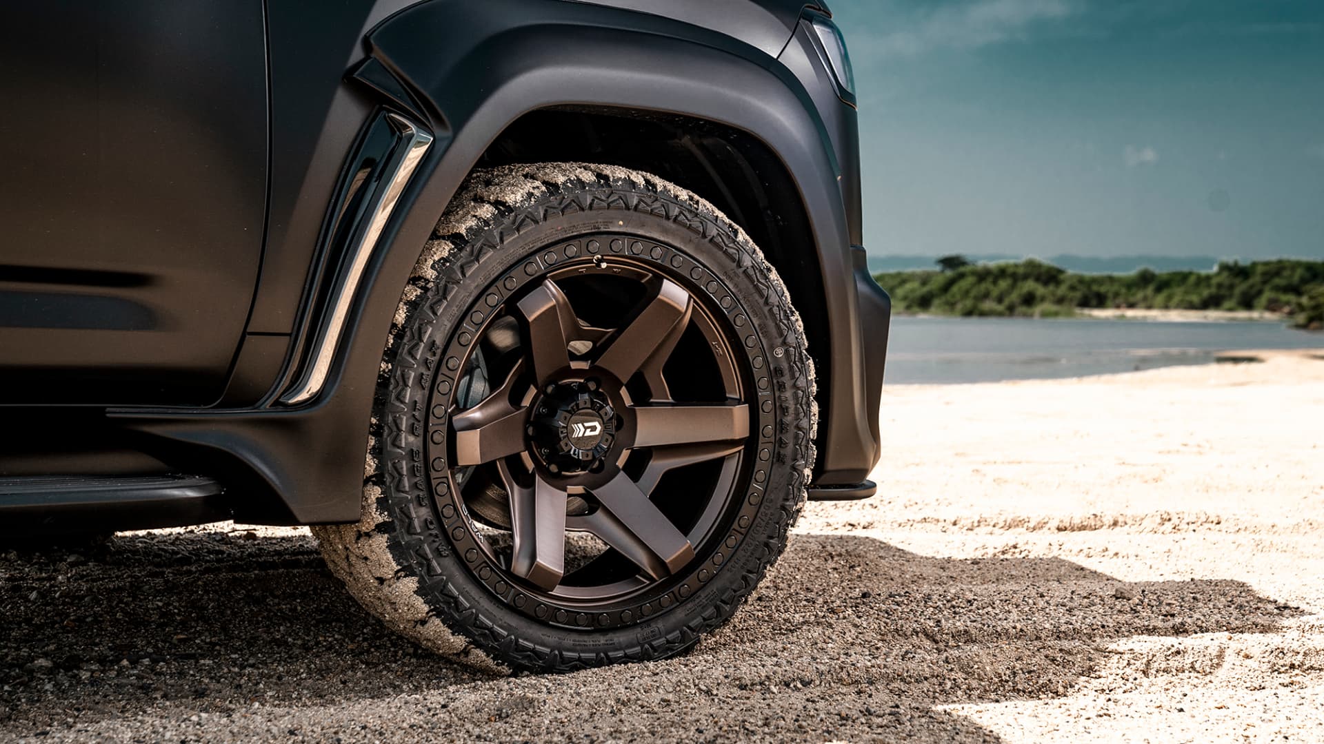 Close view of a WALD Desert Line DS001 Matte Bronze Black wheel fitted to a Toyota Land Cruiser 300 on sand