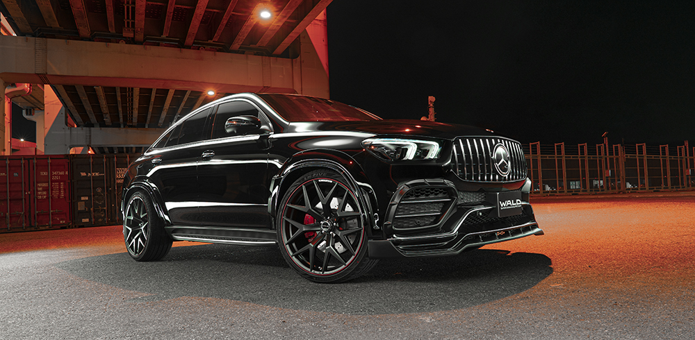 WALD Black Bison Mercedes GLE Coupe C167 front three-quarter night view under overpass with wide arches and Panamericana grille