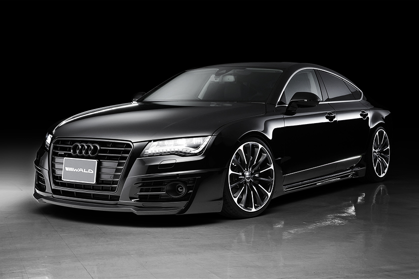 WALD Audi A7 Sportback studio front three-quarter — complete WALD Sports Line body kit in gloss black