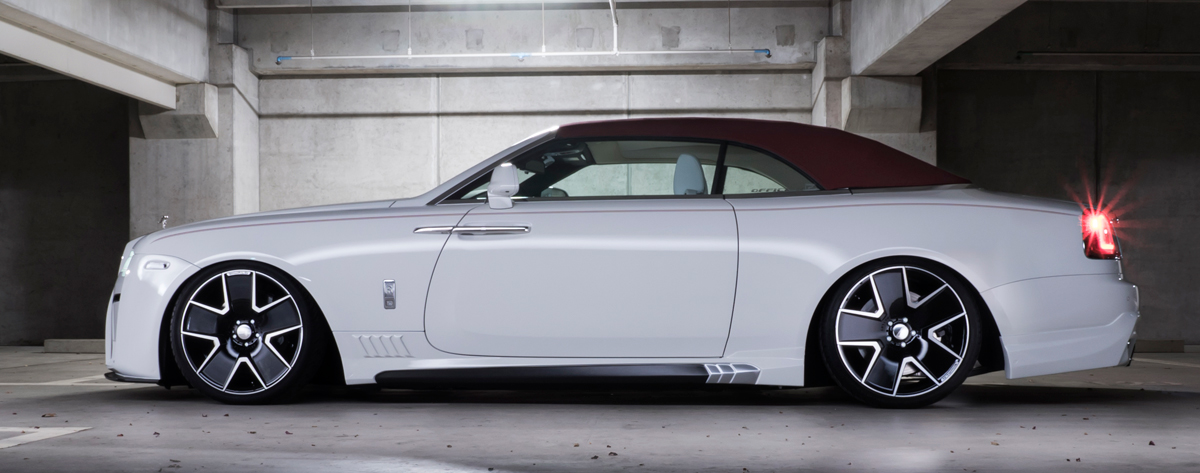 White Rolls-Royce Dawn side profile on Duchatlet IV D41C Black Polish wheels in a parking structure