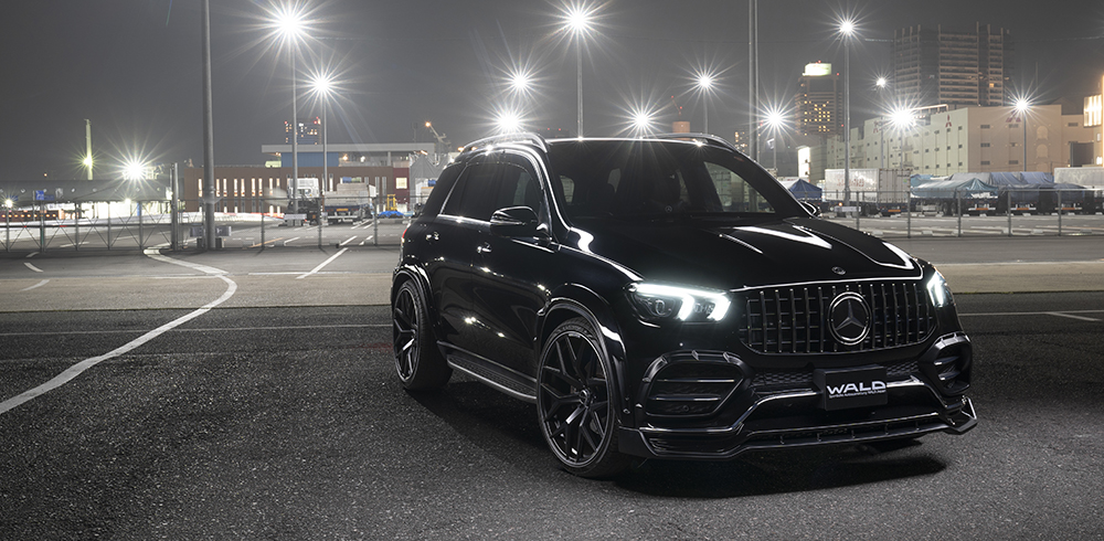 WALD Mercedes GLE W167 Black Bison front three-quarter night view with headlights on and Panamericana grille