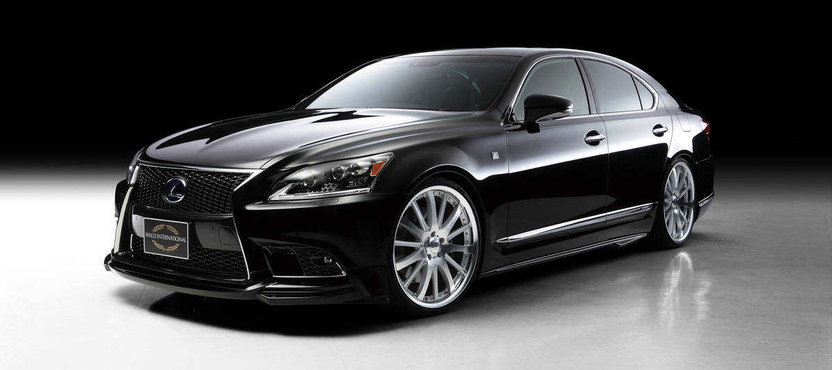 WALD Lexus LS600h F SPORT front three-quarter studio view in black with WALD front spoiler and side skirts