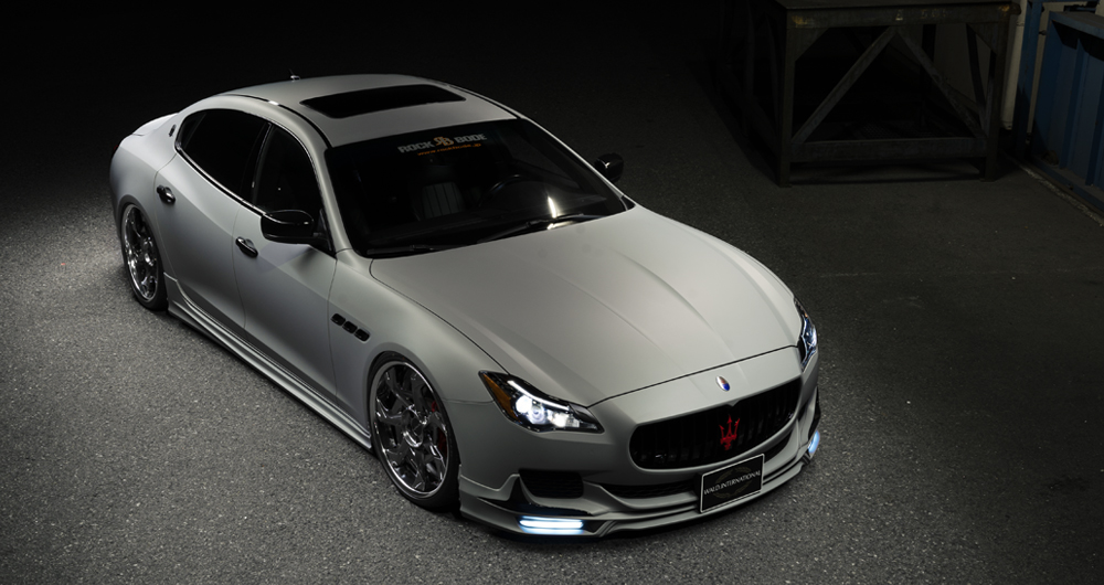Matte grey WALD Maserati Quattroporte Executive Line high-angle front three-quarter view at night