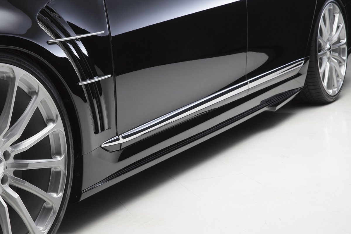 WALD Lexus LS460L side skirt detail in gloss black with chrome trim and sports fender duct