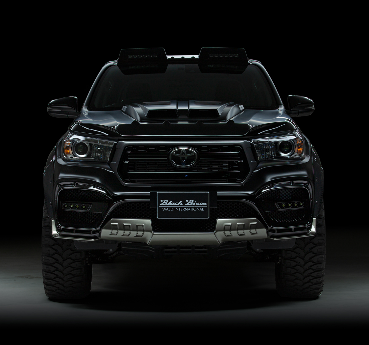 WALD Toyota Hilux GUN125 Black Bison front view with LED front bumper lamps and Black Rally Edition grille