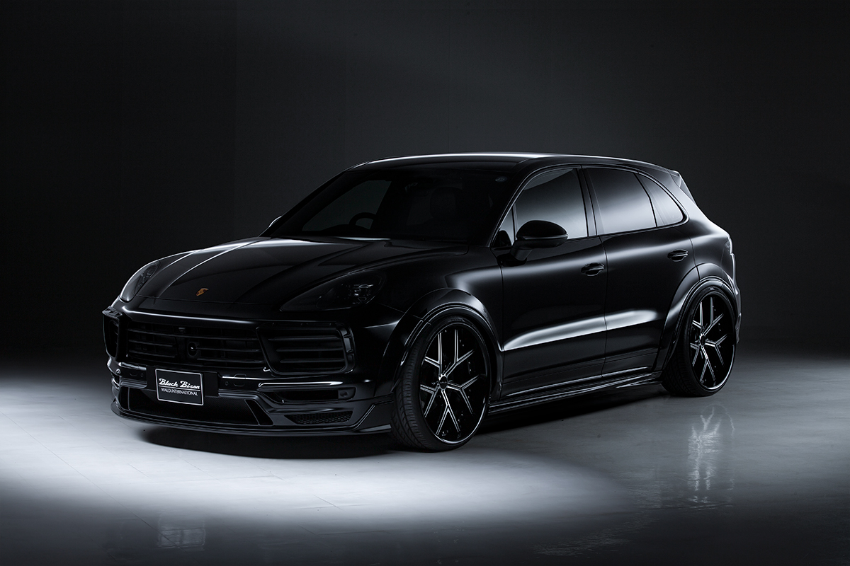 WALD Porsche Cayenne 9YA Black Bison Edition — black Cayenne front three-quarter studio view with WALD front spoiler and side skirts