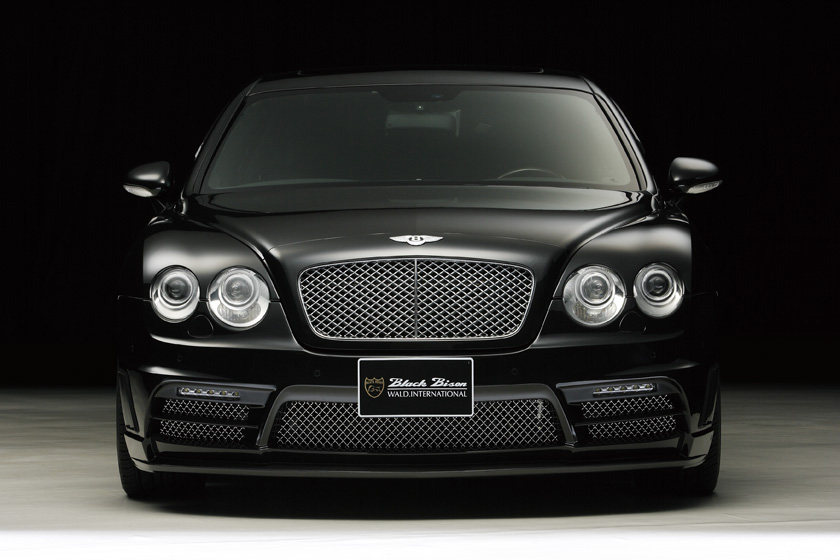WALD Bentley Continental Flying Spur Black Bison front view in studio lighting showing mesh grille and front bumper spoiler