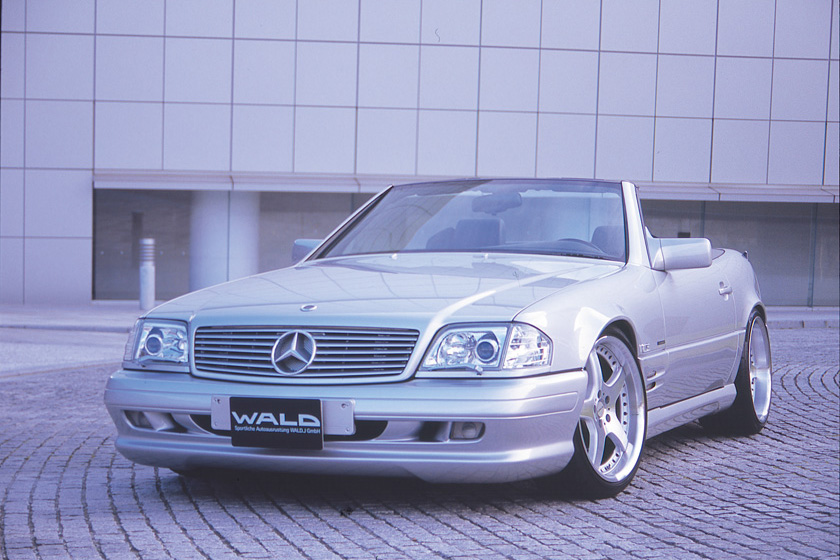 WALD Executive Line Mercedes-Benz SL-Class R129 — silver SL roadster front three-quarter view with roof down and WALD wheels