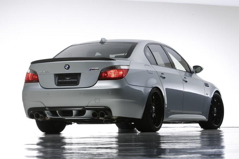 WALD BMW M5 E60 rear three-quarter studio view with WALD rear bumper spoiler and boot spoiler