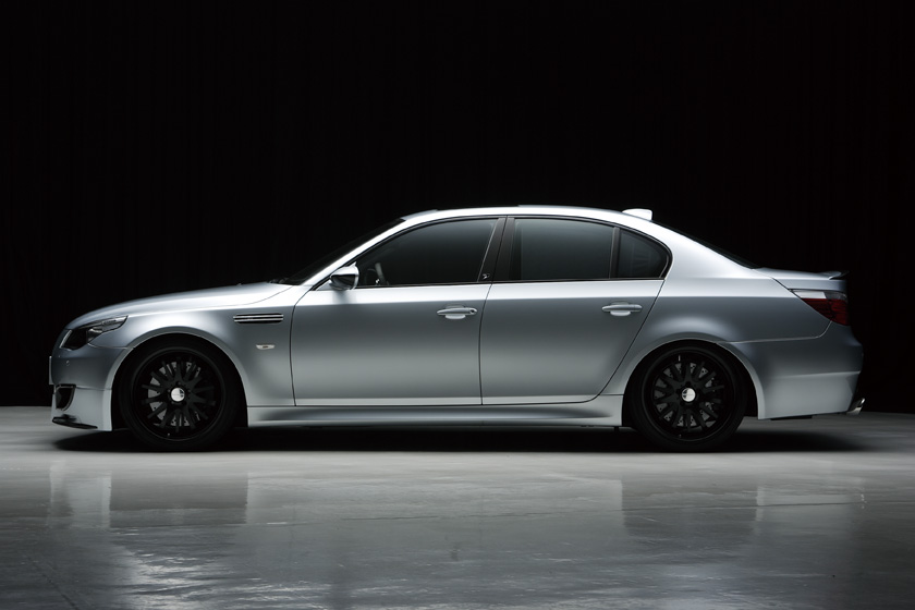 WALD BMW M5 E60 side profile showing WALD body kit and black forged wheels