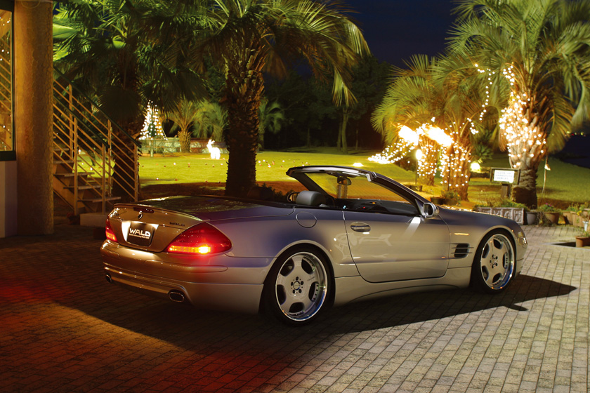 WALD Mercedes SL R230 rear view at night with illuminated brake lamp, boot spoiler and WALD rear skirt