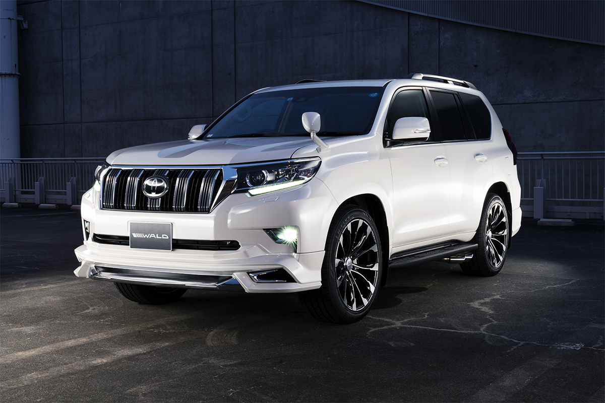 Toyota Land Cruiser Prado in white on WALD JARRET J11C Black Polish wheels, front three-quarter view