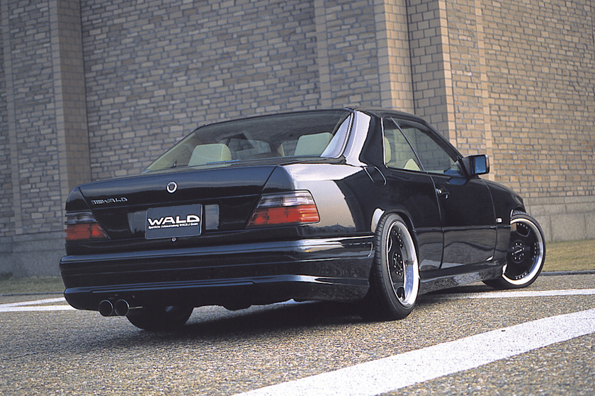 Mercedes-Benz E-Class Coupe C124 WALD V4 rear three-quarter view with boot spoiler and twin exhaust