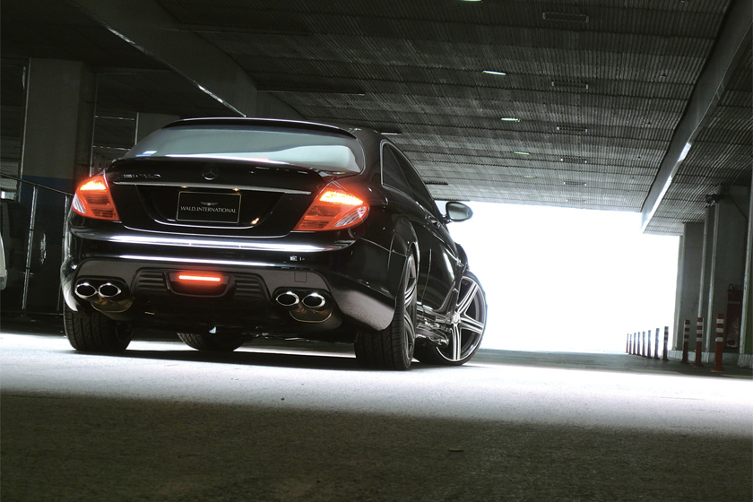 Rear view of a black Mercedes-Benz CL-Class WALD Black Bison on MAHORA M11C wheels with quad exhaust