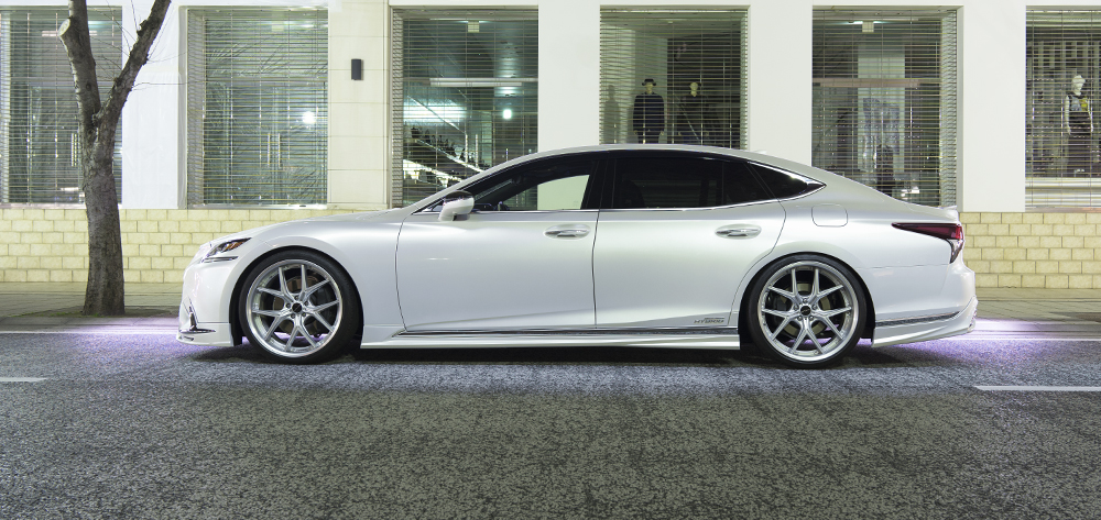 WALD Lexus LS500h Executive Version L side profile in white at night with WALD side skirts and silver wheels
