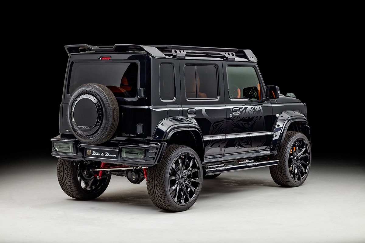 WALD Black Bison Edition Suzuki Jimny Nomade JC74W — rear three-quarter view with rear bumper spoiler, Black Bison plate and spare tyre cover