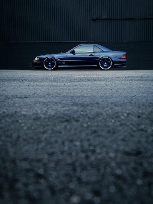 WALD Mercedes-Benz SL-Class R129 side profile with hardtop against a dark industrial backdrop
