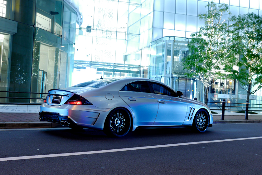 WALD Black Bison Mercedes-Benz CLS C219 rear three-quarter view on a city street with boot spoiler, rear bumper spoiler and quad exhaust tips