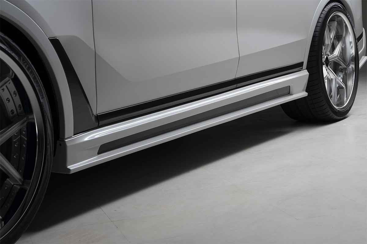 WALD BMW X7 G07 side skirt detail showing WALD side skirt profile and welcome lamp housing