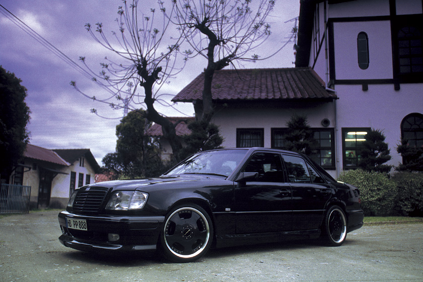 Black Mercedes-Benz E-Class W124 WALD V4 side profile with WALD side skirts and lowered stance