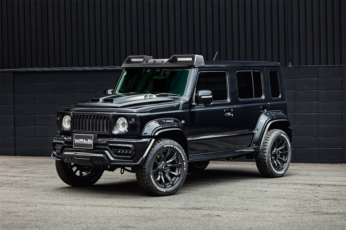 Suzuki Jimny Nomade WALD Black Bison Edition on JARRET J11C 1/5 17-inch Matt Black Polish wheels, front three-quarter view