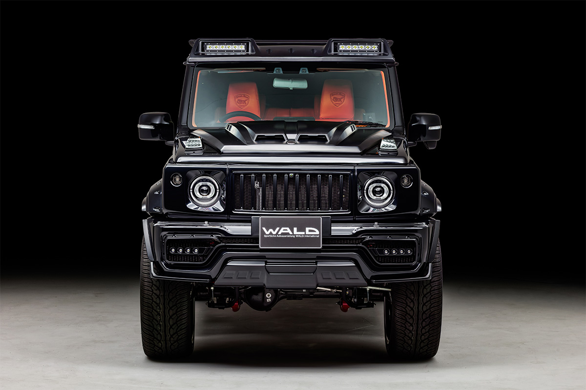 WALD Suzuki body kit — black Suzuki Jimny with WALD front bumper, bonnet scoop and roof light bars