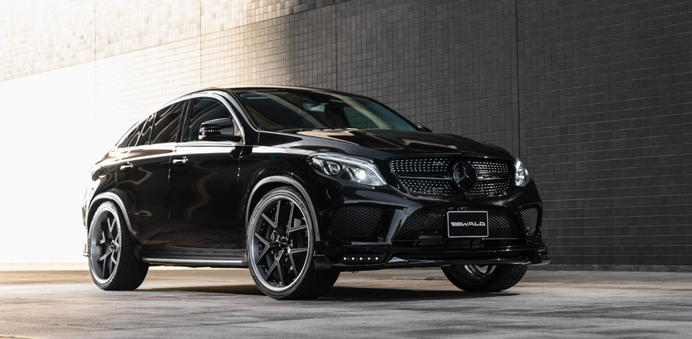 WALD Sports Line Mercedes GLE Coupe C292 AMG Line front three-quarter on location with add-on front spoiler and LED lamps