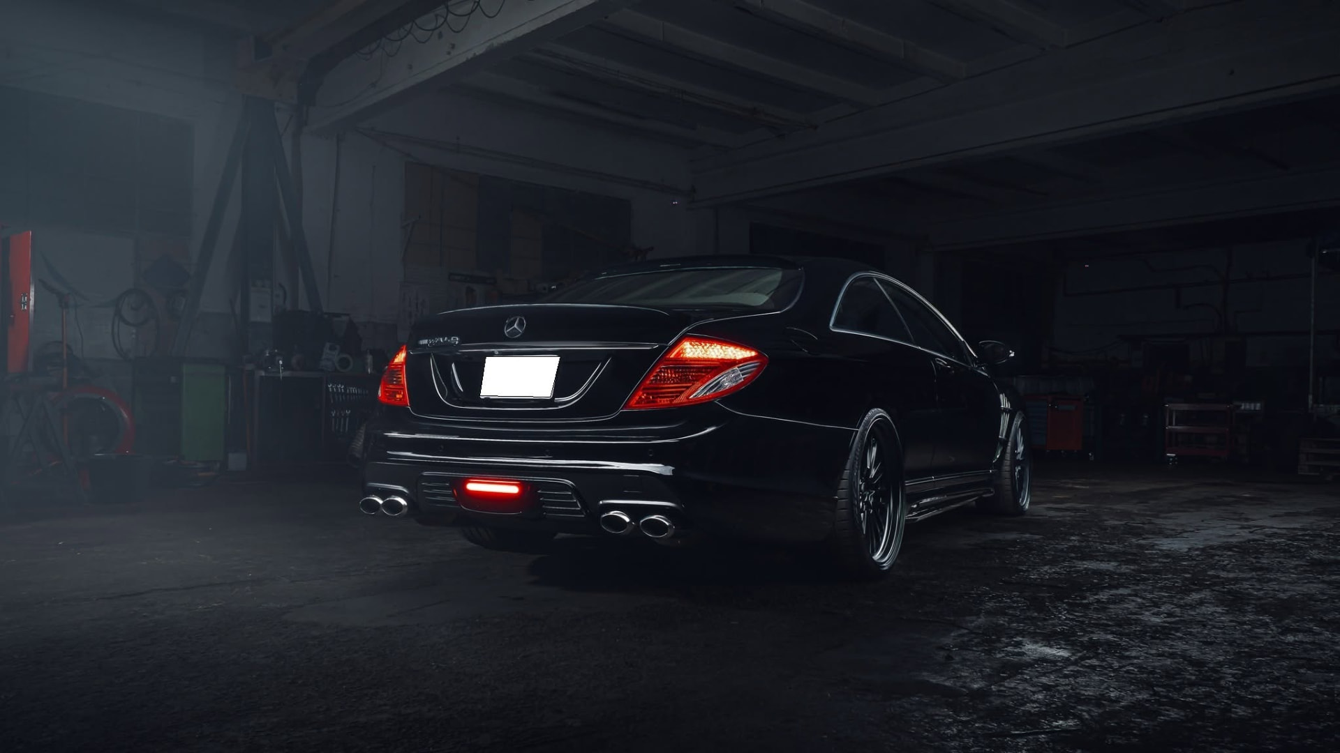WALD Mercedes-Benz CL C216 rear three-quarter view with illuminated rear lamps and quad exhaust tips