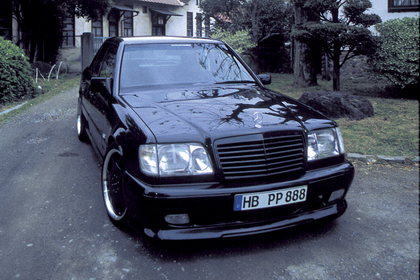 Black Mercedes-Benz E-Class W124 WALD V4 front view showing WALD front spoiler detail