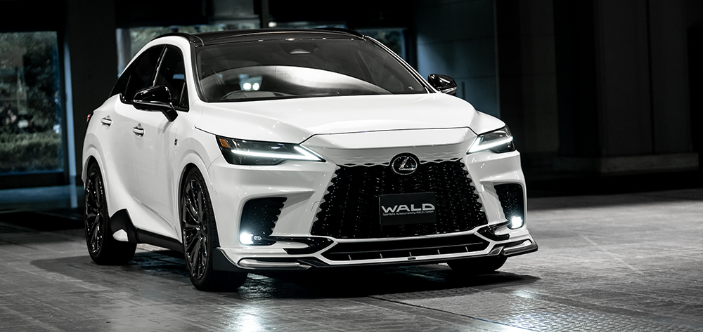 WALD Lexus RX front three-quarter — white Lexus RX350 F SPORT with WALD ABS front spoiler and illuminated LED headlights