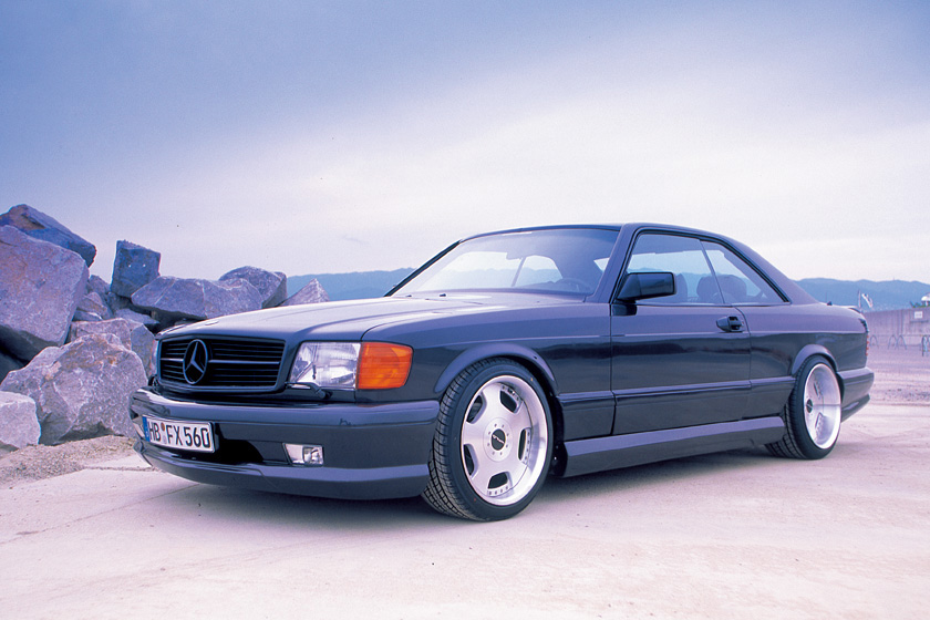 WALD Mercedes-Benz CL-Class C126 1980–1991 — front three-quarter side profile of dark coupé on dished alloy wheels by the water