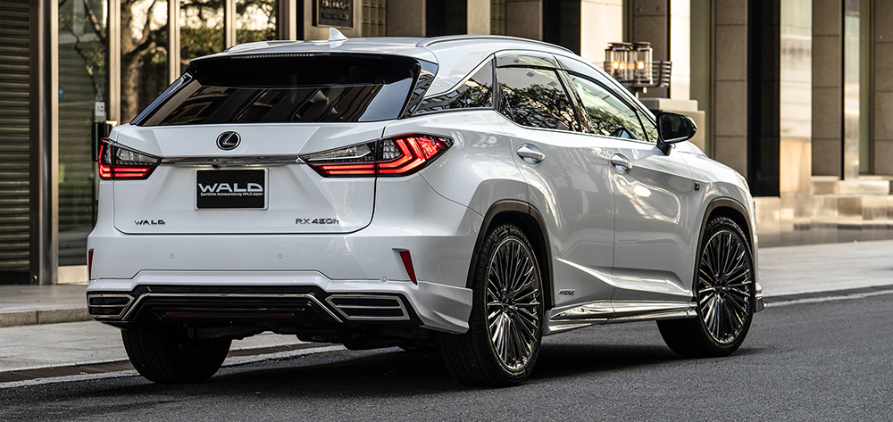 White WALD Lexus RX450h F SPORT rear three-quarter view showing rear skirt and quad exhaust styling