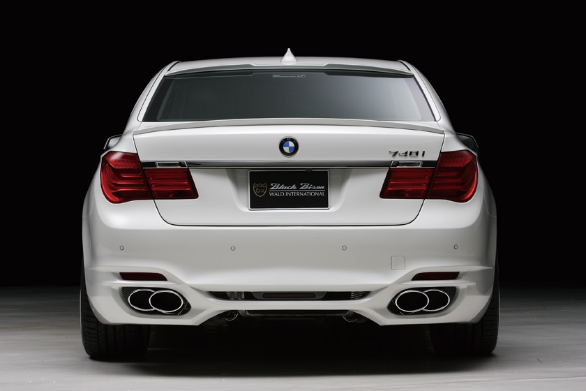 WALD BMW 7 Series F02 Black Bison direct rear view of white 740i showing WALD boot spoiler and twin oval exhaust outlets