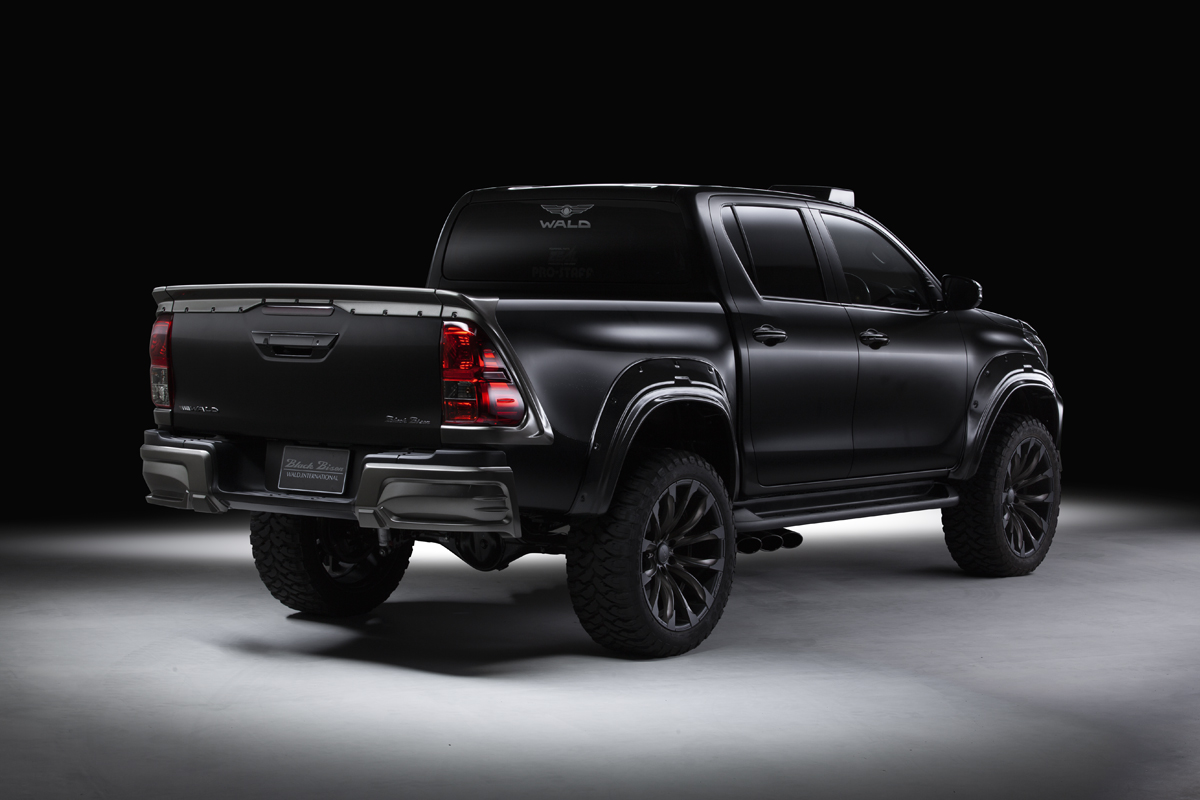 WALD Black Bison Toyota Hilux GUN125 rear three-quarter view with rear spats and tailgate spoiler
