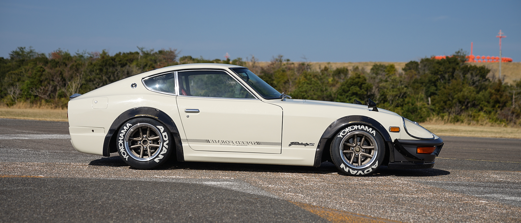White Nissan Fairlady Z S30 side profile on WALD Octopus Racing 15 inch wheels